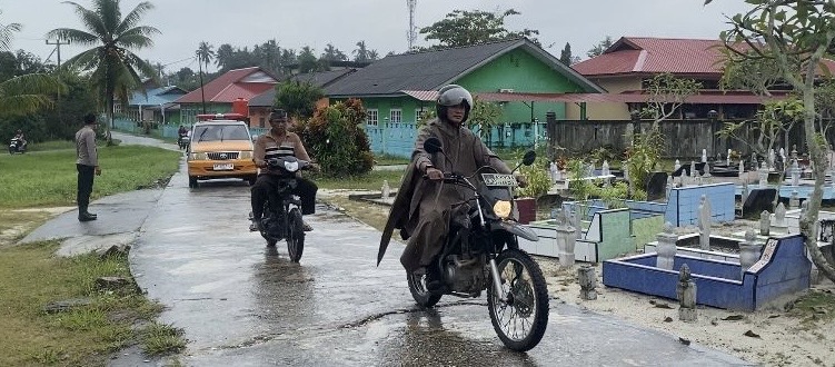 Bhabinkamtibas Kelurahan Dabo saat mengawal jenazah warga yang akan di makamkan (Foto : Zonamu/Hendri)