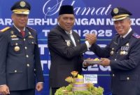 Wakil Bupati Karimun, Rocky Marciano Bawole memberikan potongan tumpeng pertama peringatan Hari Perhubungan Nasional 2025 kepada Kepala Bandara RHA Karimun, M. Subiat Wiranata Kusumah | Foto: Azis