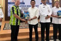 Pelaksana Tugas Kepala Dinas Penanaman Modal dan Pelayanan Terpadu Satu Pintu (DPMPTSP) Kabupaten Lingga, Widi Satoto saat menerima hasi capaian realisasi investasi Lingga | Foto : Zonamu/Ist